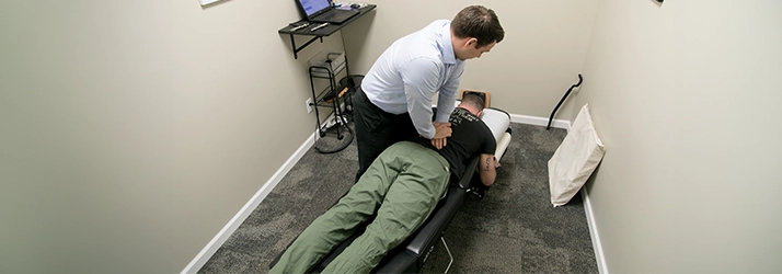 Chiropractor Warsaw IN Matthew Palladino Adjusting Patient