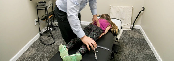 Chiropractor Warsaw IN Matthew Palladino Adjusting Pediatric Patient