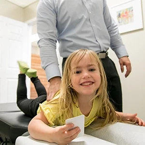 Chiropractor Warsaw IN Matthew Palladino With Pediatric Patient